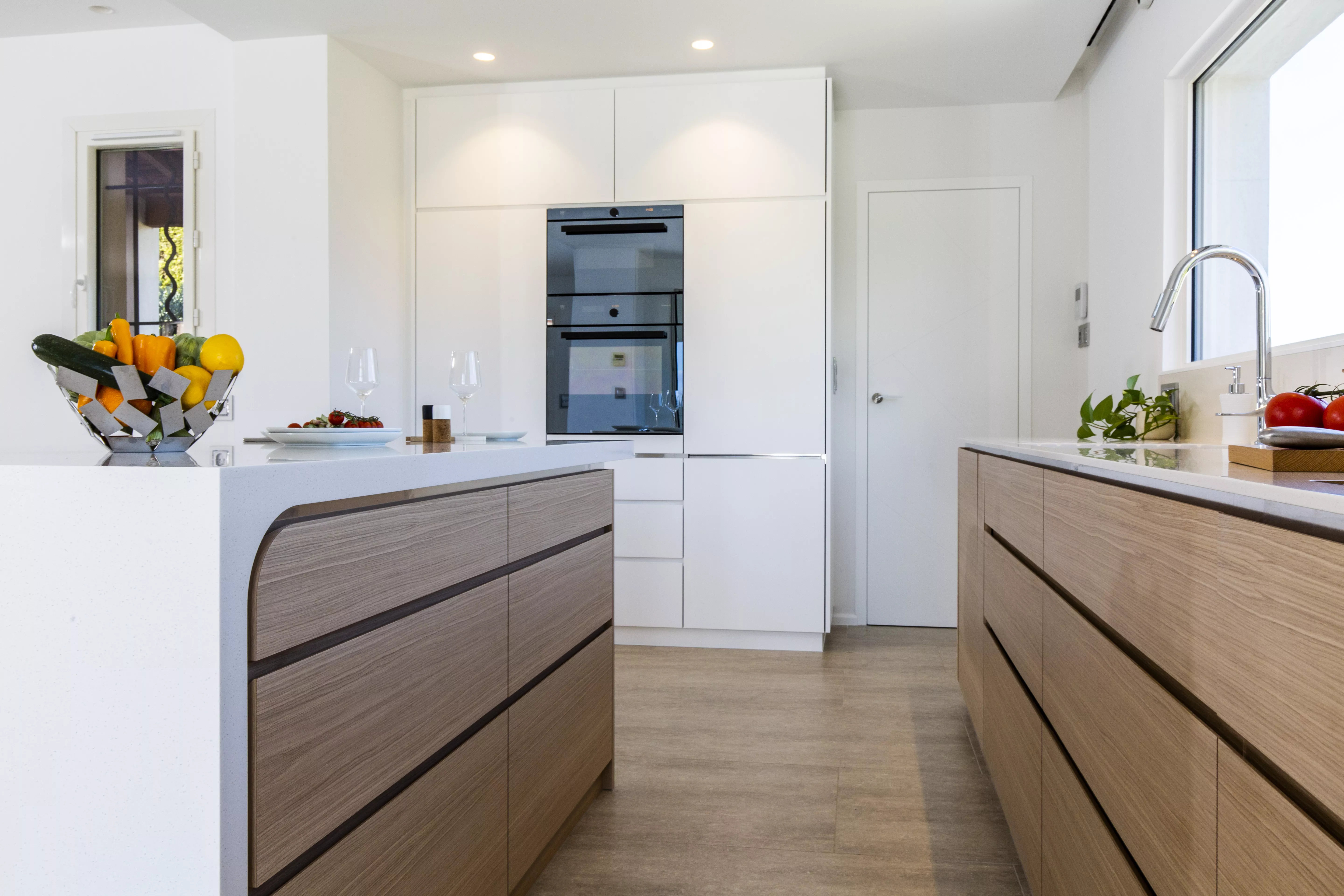 A contemporary, light-filled HIMACS kitchen with a mountain view