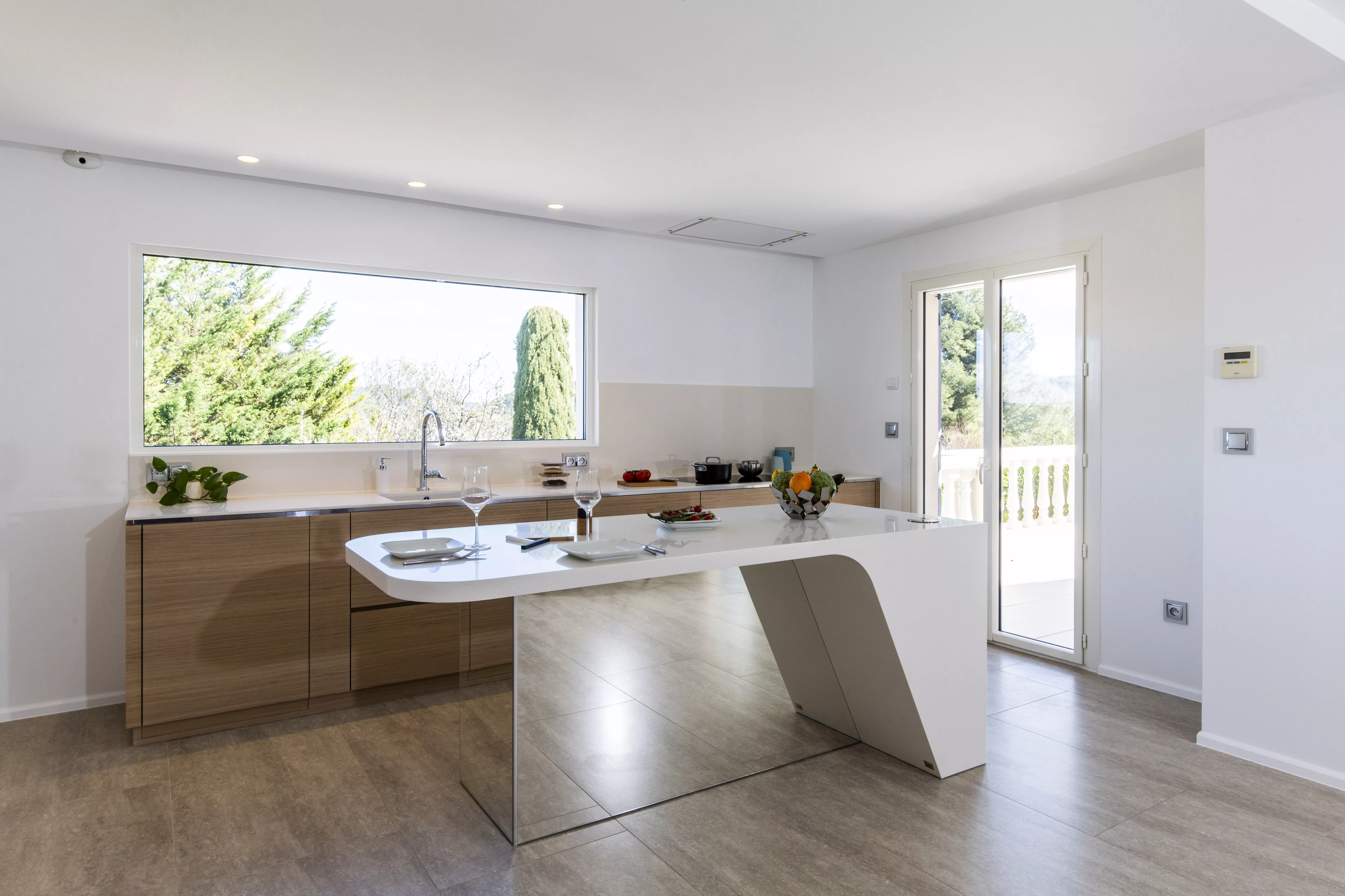 A contemporary, light-filled HIMACS kitchen with a mountain view