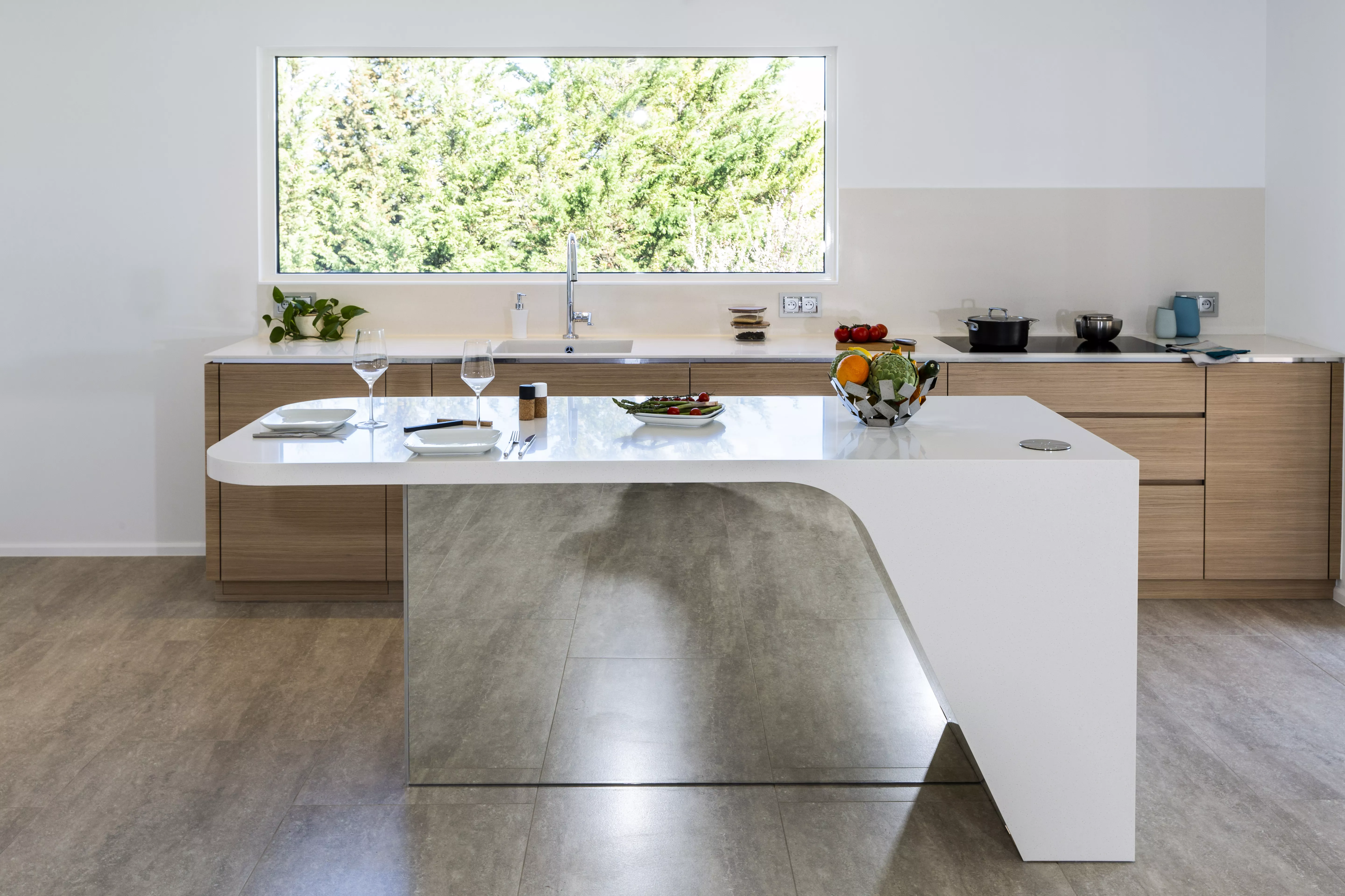 A contemporary, light-filled HIMACS kitchen with a mountain view