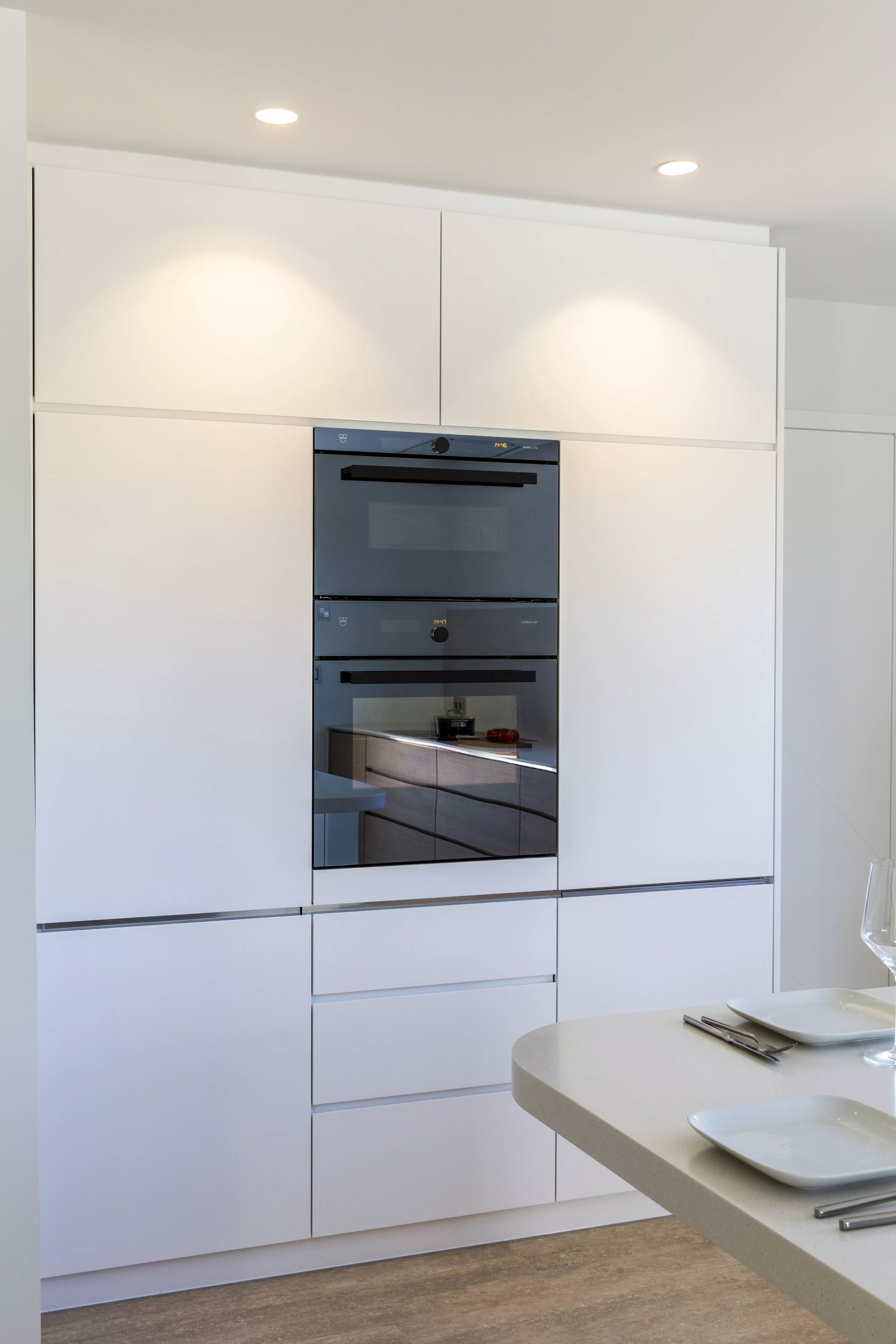 A contemporary, light-filled HIMACS kitchen with a mountain view