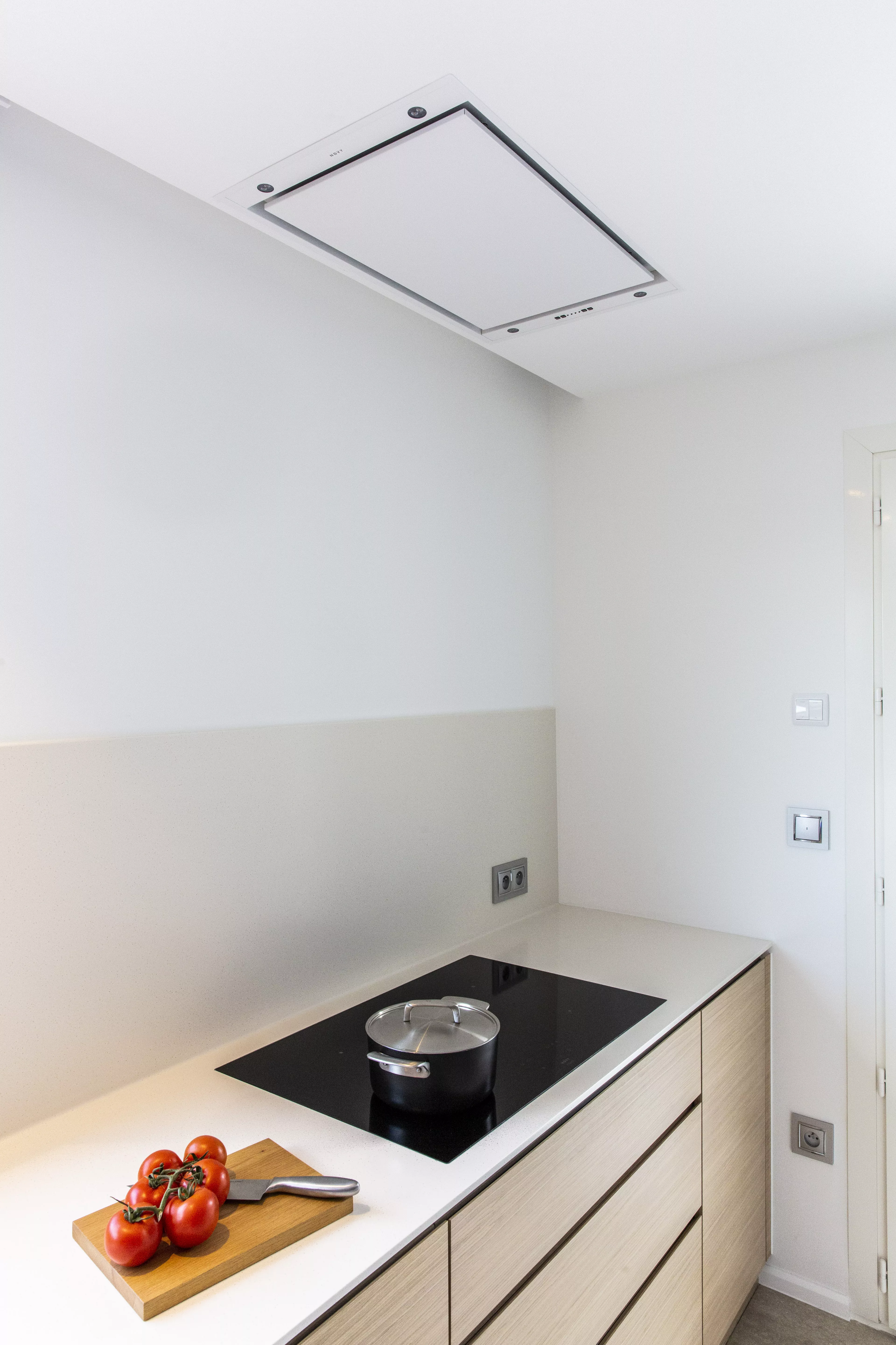 A contemporary, light-filled HIMACS kitchen with a mountain view