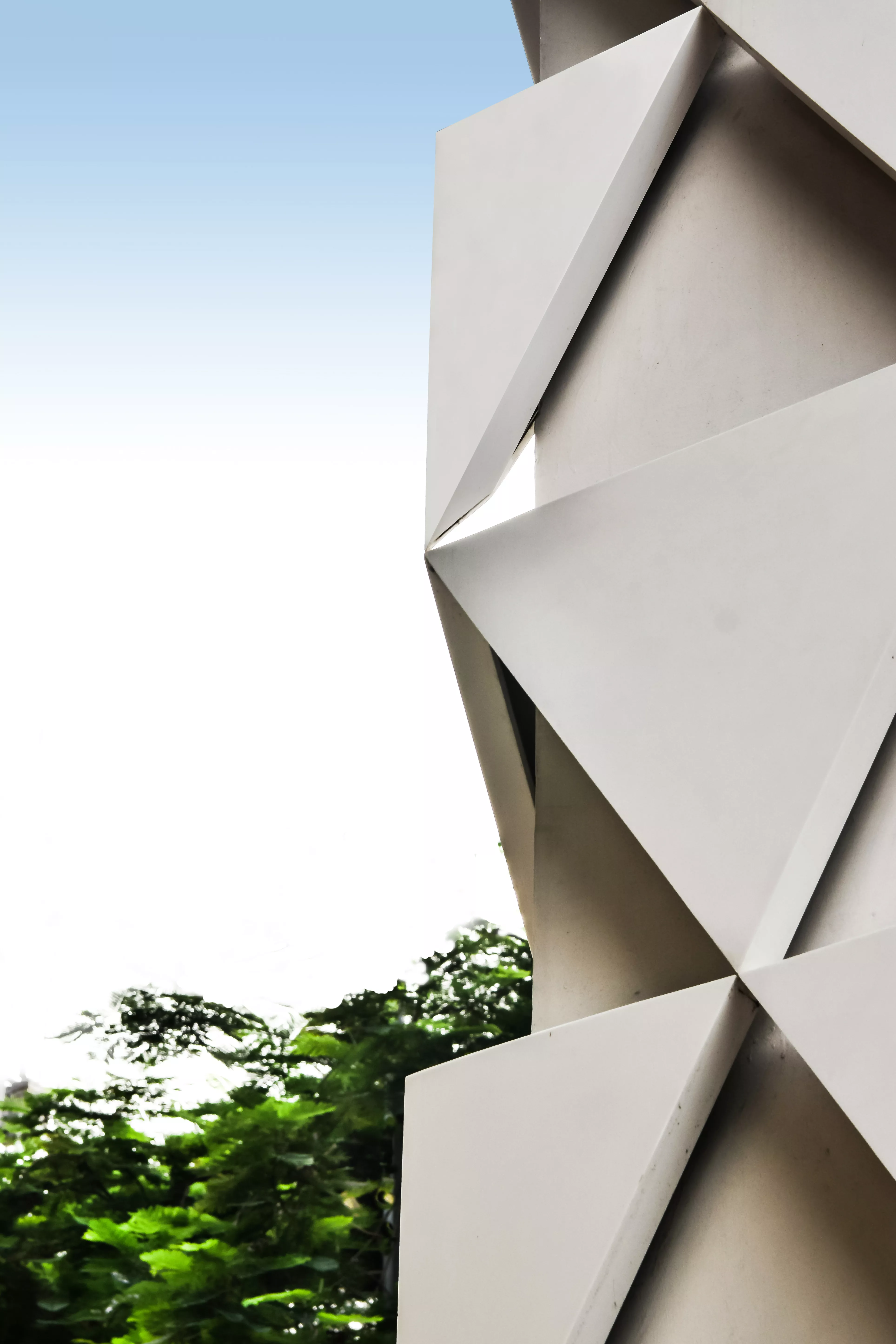 A sculptural, geometric façade made of HIMACS for JK House